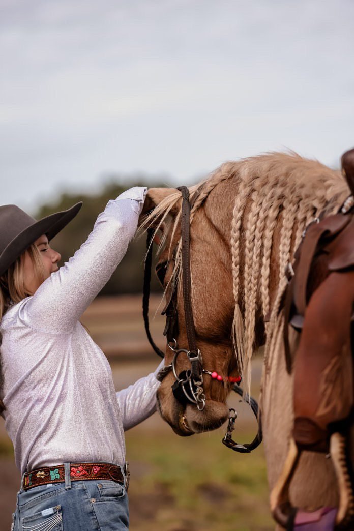 Braiding a mane on a Boca Brand shoot