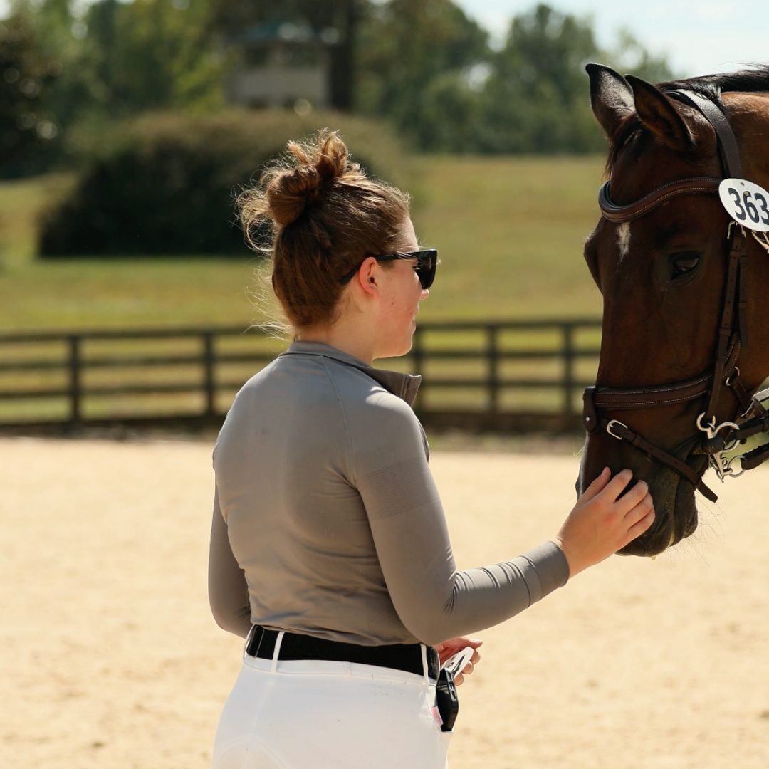 A rider with her horse at a show
